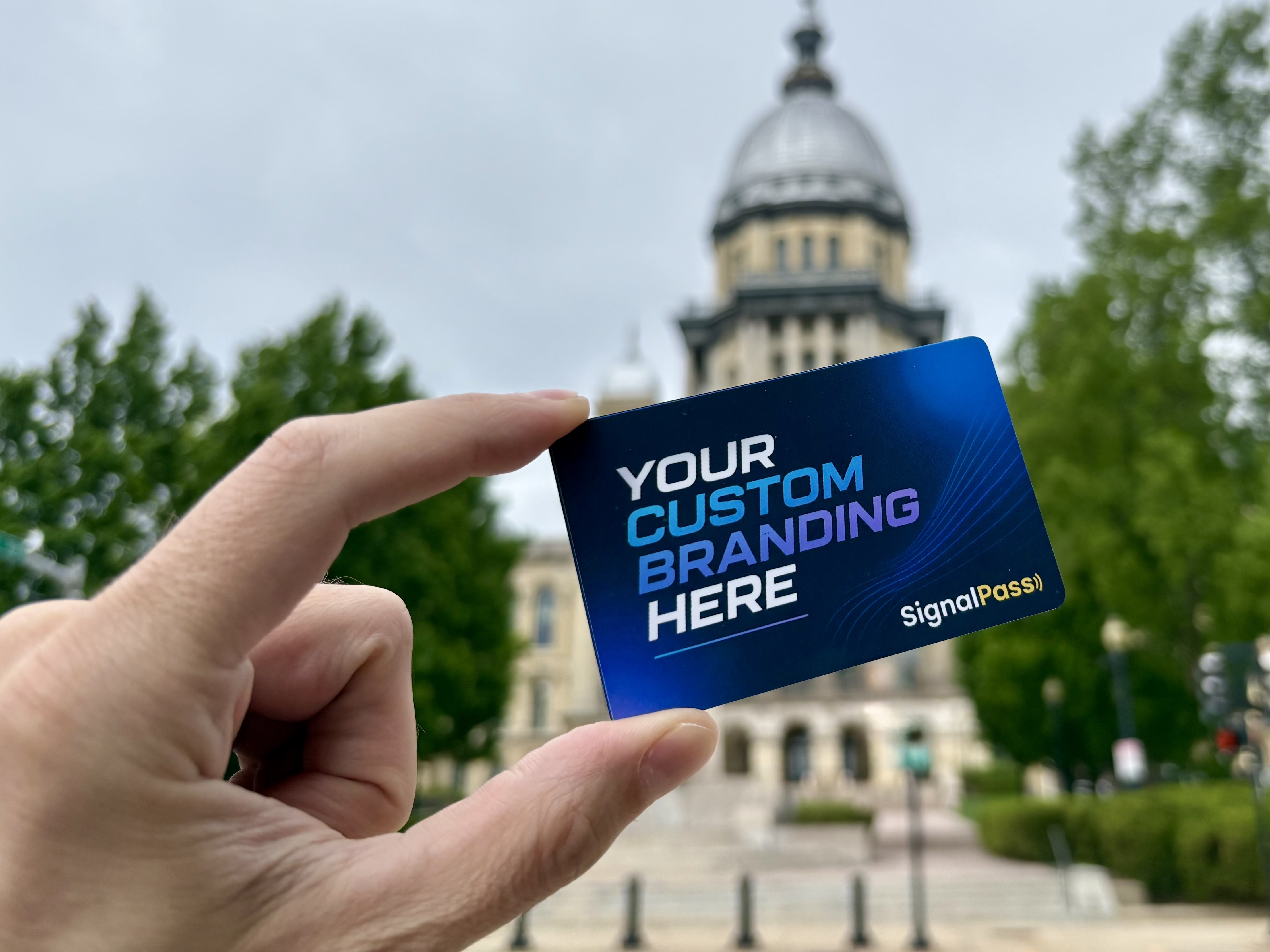Custom SignalPass card held outside the Illinois Capitol